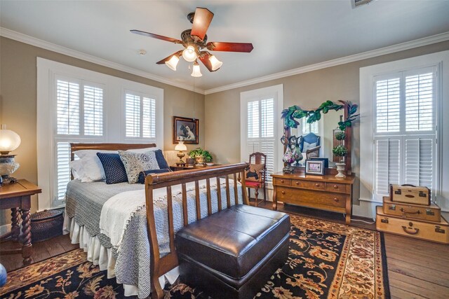 bedroom featuring ceiling fan, wood-type flooring, and crown molding