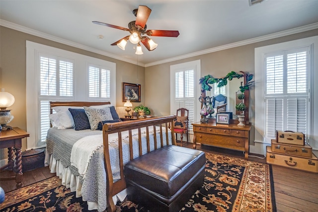 bedroom with ornamental molding, hardwood / wood-style floors, and ceiling fan