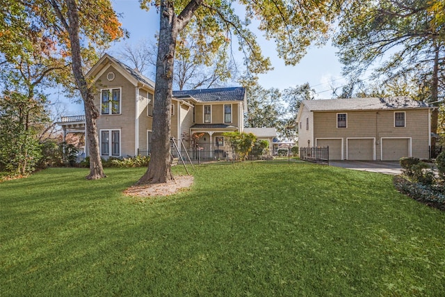 rear view of house featuring a lawn and a garage