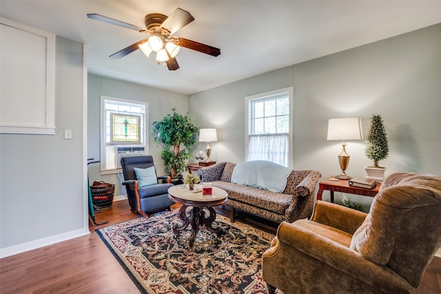 living room featuring dark hardwood / wood-style flooring, ceiling fan, and cooling unit