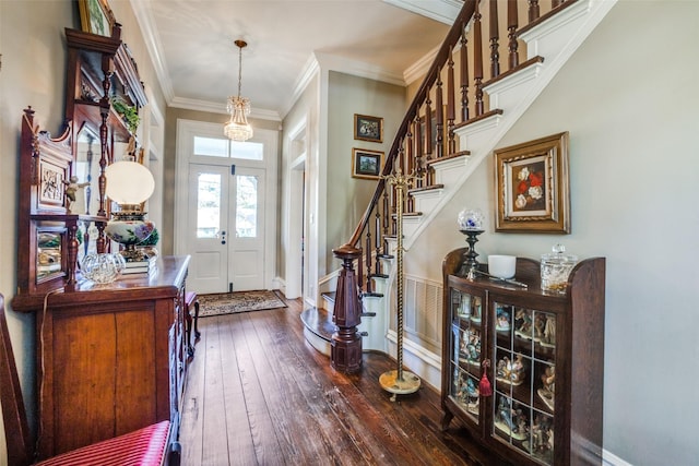 foyer entrance with french doors, dark hardwood / wood-style flooring, and ornamental molding