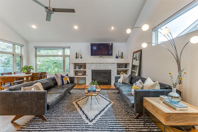 living room featuring hardwood / wood-style flooring, vaulted ceiling, and ceiling fan