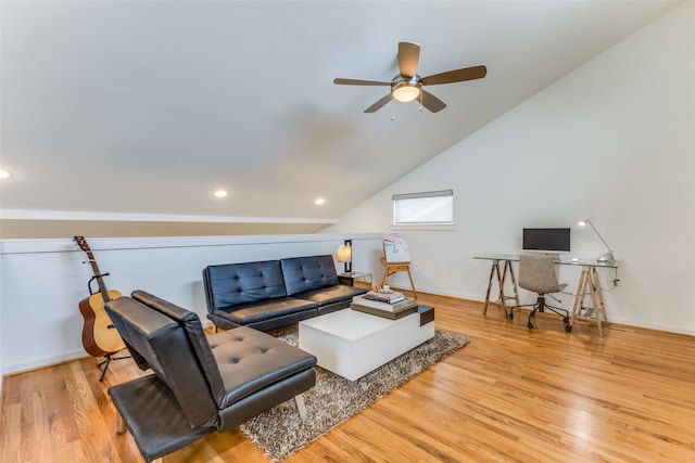 living room with ceiling fan, lofted ceiling, and light hardwood / wood-style flooring