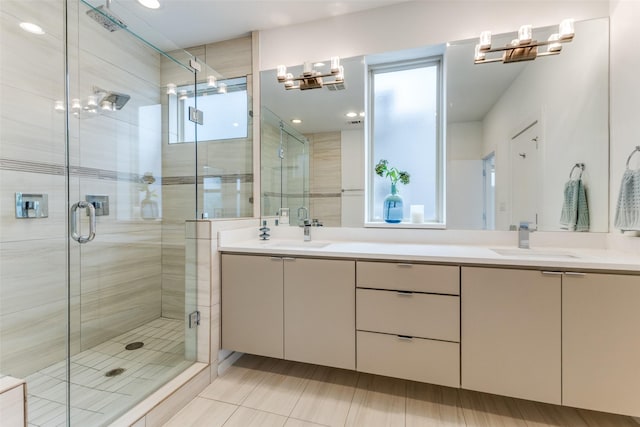 bathroom featuring tile patterned flooring, vanity, and a shower with shower door