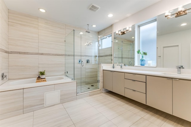 bathroom featuring tile patterned flooring, vanity, and independent shower and bath