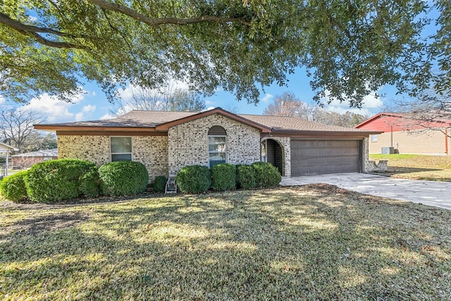 single story home featuring a garage and a front yard