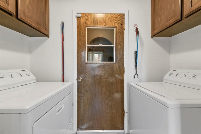 washroom with cabinets and separate washer and dryer