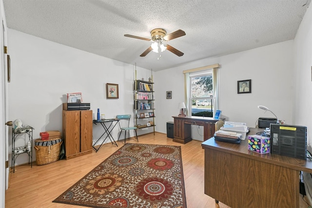 office space with hardwood / wood-style flooring, ceiling fan, and a textured ceiling