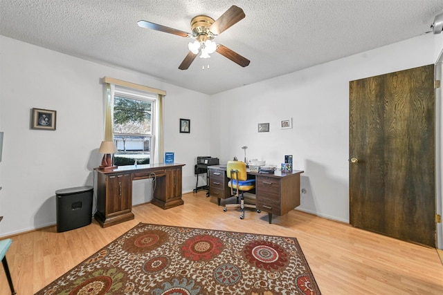 office featuring ceiling fan, light hardwood / wood-style flooring, and a textured ceiling