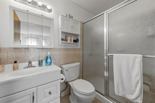 bathroom with backsplash, toilet, vanity, and walk in shower