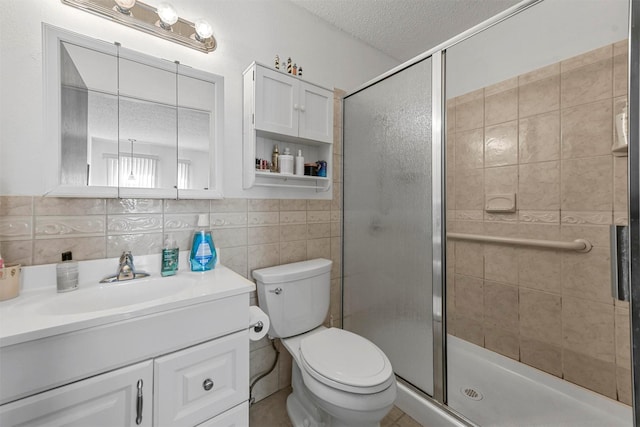 bathroom with tasteful backsplash, a textured ceiling, toilet, vanity, and a shower with shower door