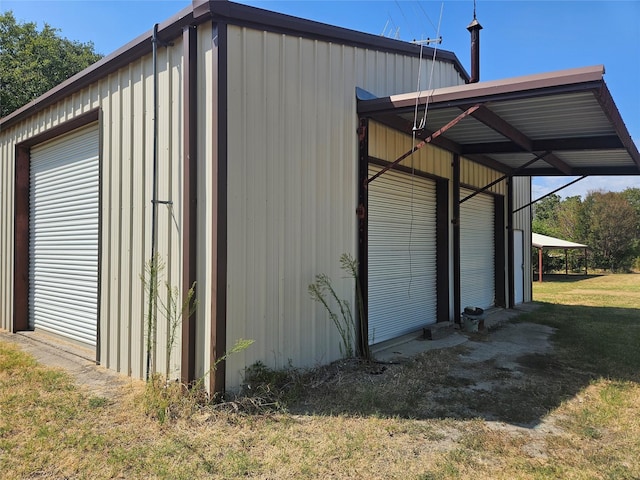 view of outbuilding featuring a yard and a carport