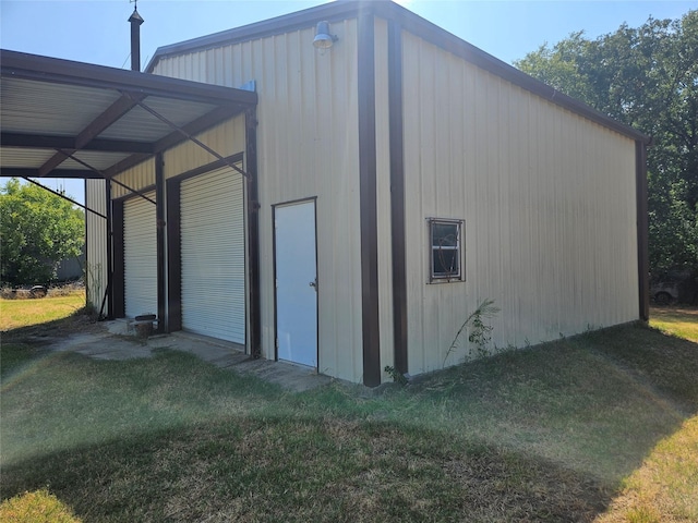 view of outbuilding featuring a yard