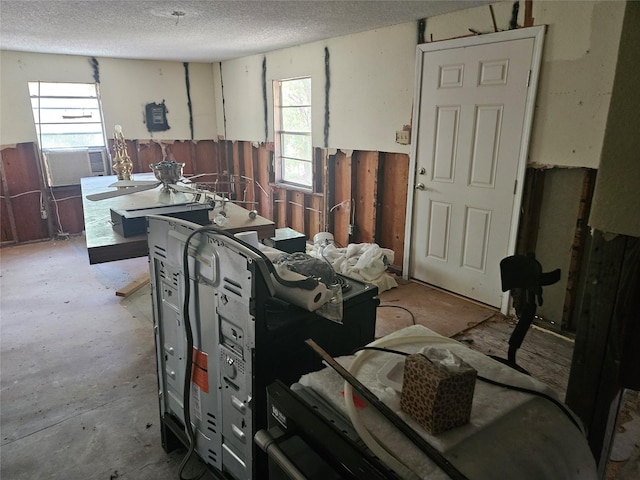 interior space featuring a textured ceiling and cooling unit