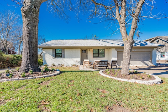 ranch-style home with a front yard and a garage