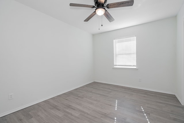 empty room featuring ceiling fan and light hardwood / wood-style flooring