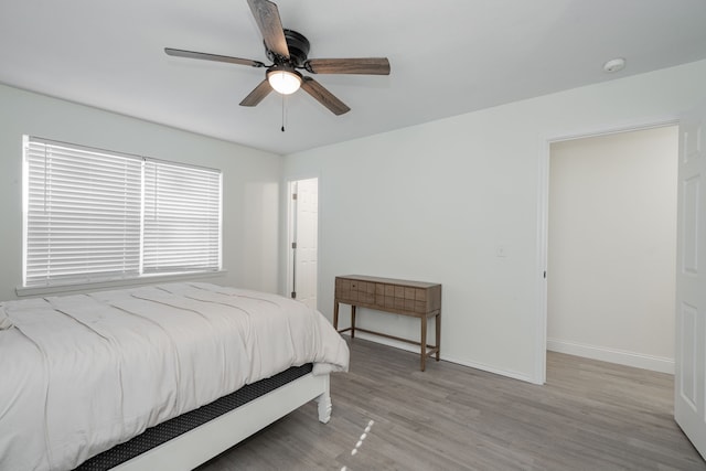 bedroom with light hardwood / wood-style flooring and ceiling fan