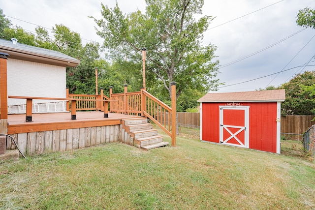 view of yard with a wooden deck and a storage unit