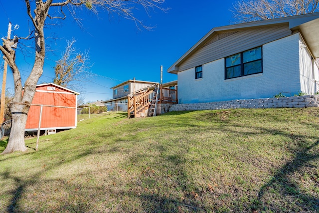 view of yard with a shed and a deck