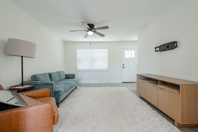 living room with ceiling fan and light hardwood / wood-style flooring