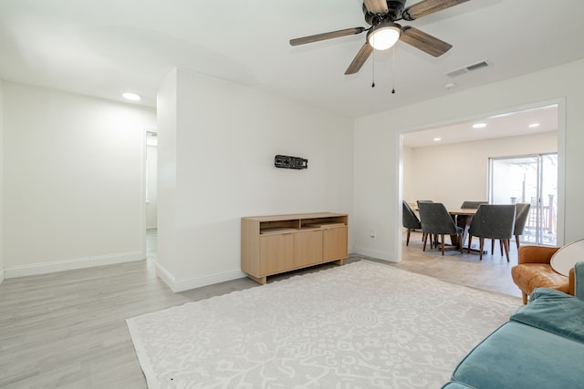 living room featuring ceiling fan and light wood-type flooring