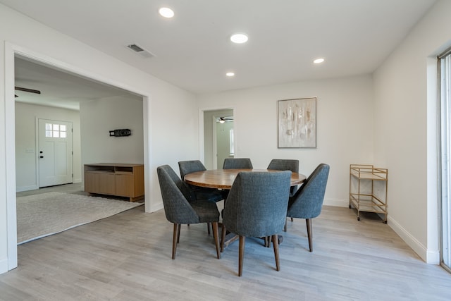 dining space with light wood-type flooring and ceiling fan