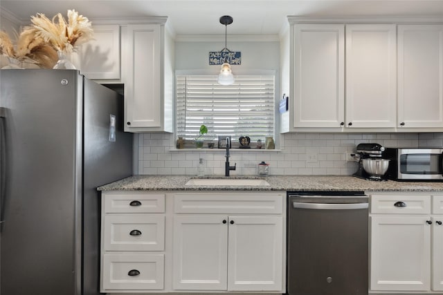 kitchen with white cabinetry, sink, decorative backsplash, appliances with stainless steel finishes, and ornamental molding