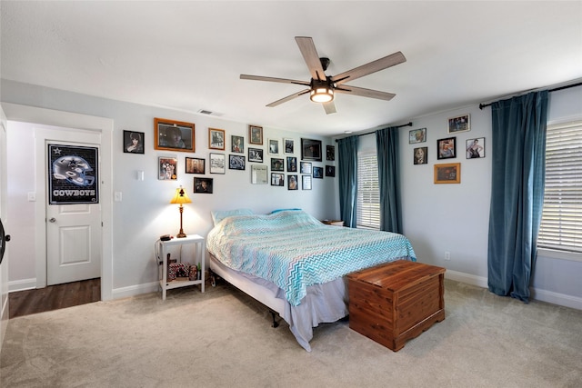 bedroom with carpet flooring, ceiling fan, and multiple windows