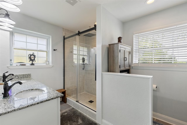 bathroom featuring vanity and a shower with shower door