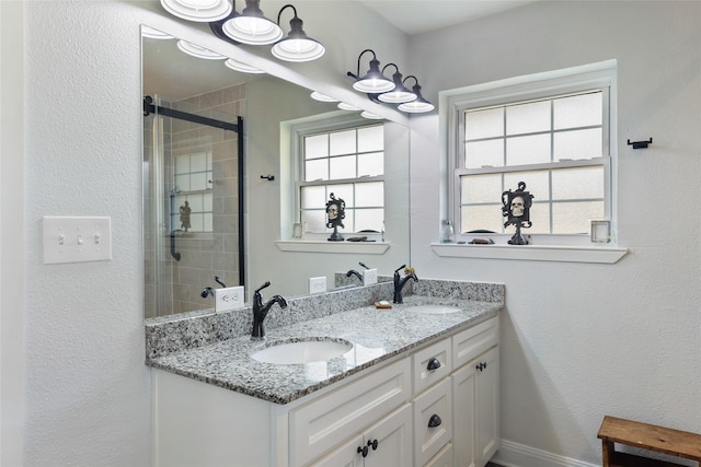 bathroom featuring vanity and an enclosed shower