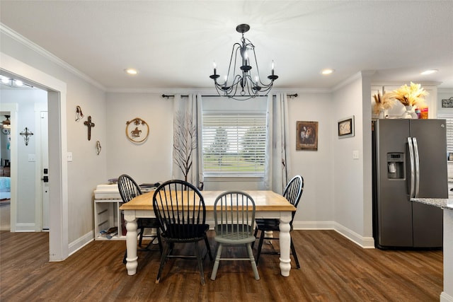 dining space featuring dark hardwood / wood-style flooring, crown molding, and a chandelier