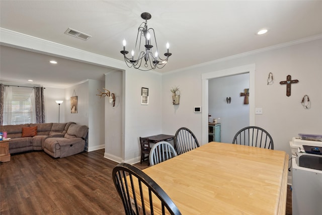 dining area with dark wood-type flooring, an inviting chandelier, and crown molding