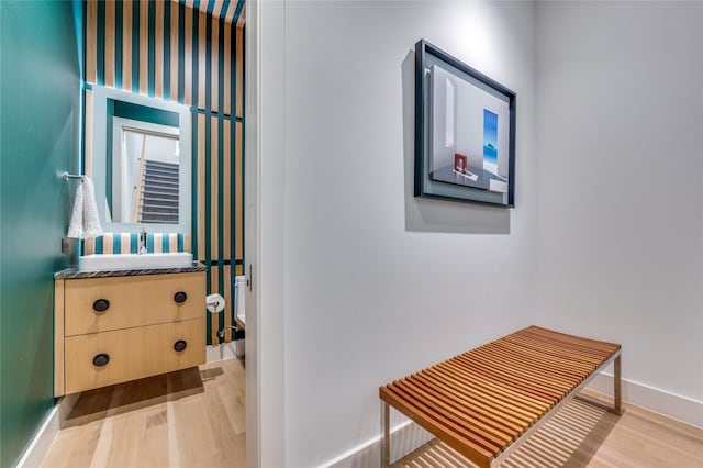 hall featuring light wood-type flooring and sink