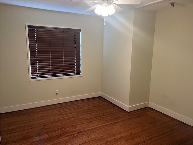 unfurnished room with dark hardwood / wood-style floors and ceiling fan