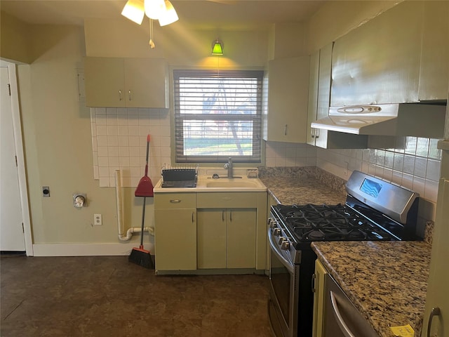 kitchen with tasteful backsplash, stainless steel gas range oven, sink, and stone countertops