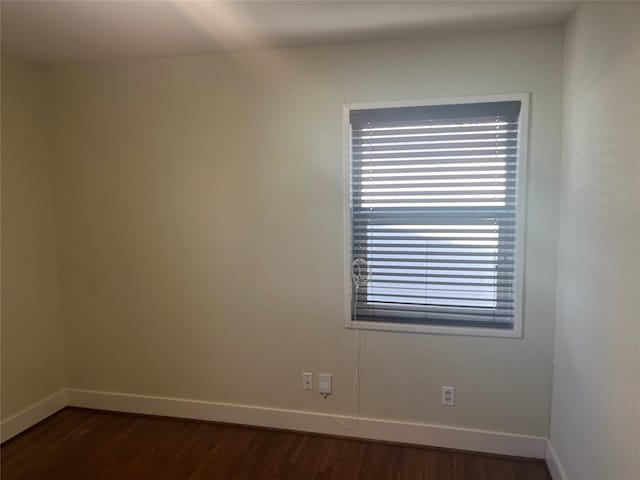 unfurnished room featuring dark hardwood / wood-style flooring