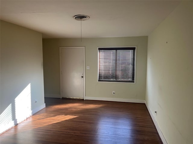 empty room with dark wood-type flooring