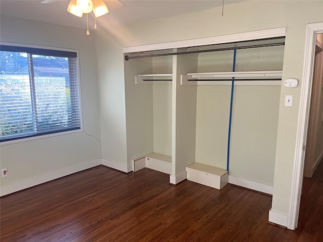 unfurnished bedroom featuring dark hardwood / wood-style flooring, a closet, and ceiling fan