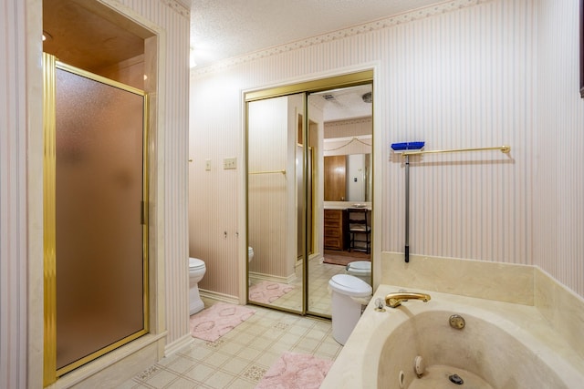 bathroom featuring shower with separate bathtub, toilet, and a textured ceiling