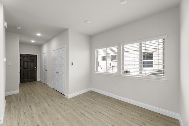 unfurnished room featuring plenty of natural light and light hardwood / wood-style flooring