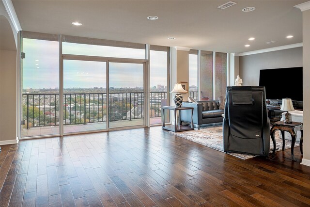 living room with plenty of natural light, expansive windows, wood-type flooring, and ornamental molding