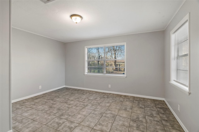 unfurnished room with tile patterned floors and crown molding