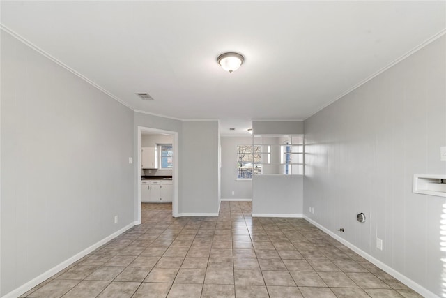 unfurnished room with light tile patterned floors, ornamental molding, visible vents, and baseboards