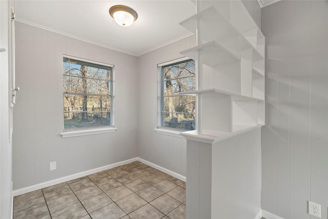 interior space featuring crown molding and light tile patterned floors