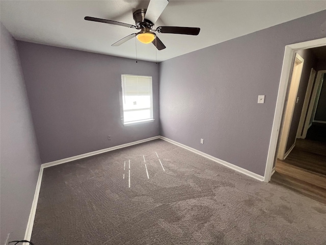 empty room featuring ceiling fan and carpet floors