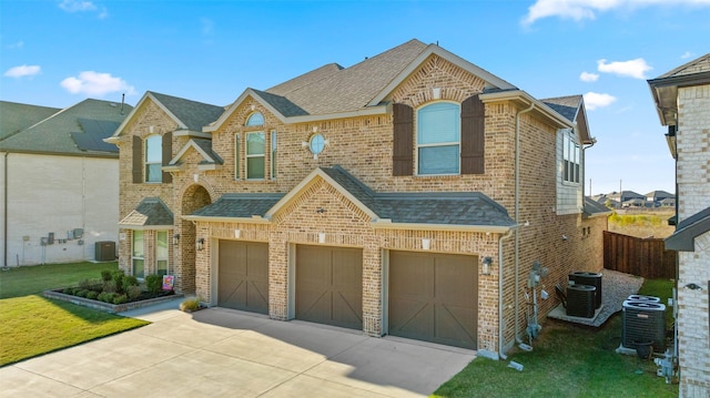 view of front of home featuring central AC unit and a garage