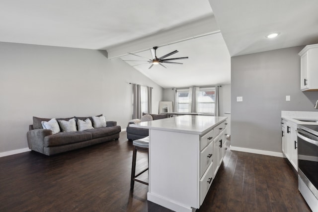 kitchen with a breakfast bar, dark wood-type flooring, white cabinets, lofted ceiling with beams, and stainless steel electric stove