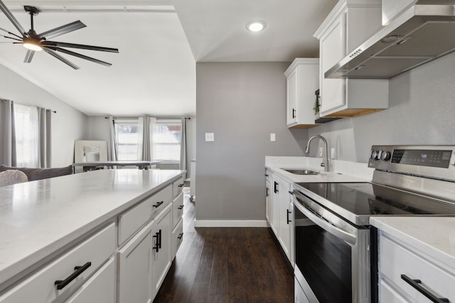 kitchen featuring wall chimney range hood, sink, electric range, dark hardwood / wood-style floors, and white cabinets