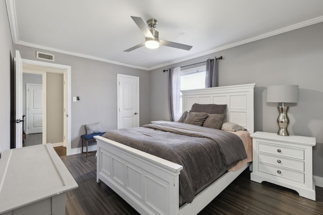 bedroom featuring dark wood-type flooring, ornamental molding, and ceiling fan