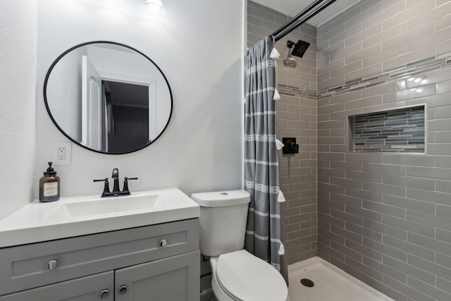 bathroom featuring vanity, curtained shower, and toilet